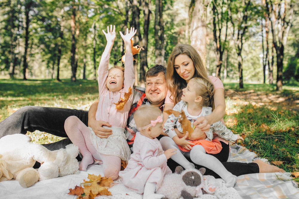 A family enjoying time together on a picnic blanket